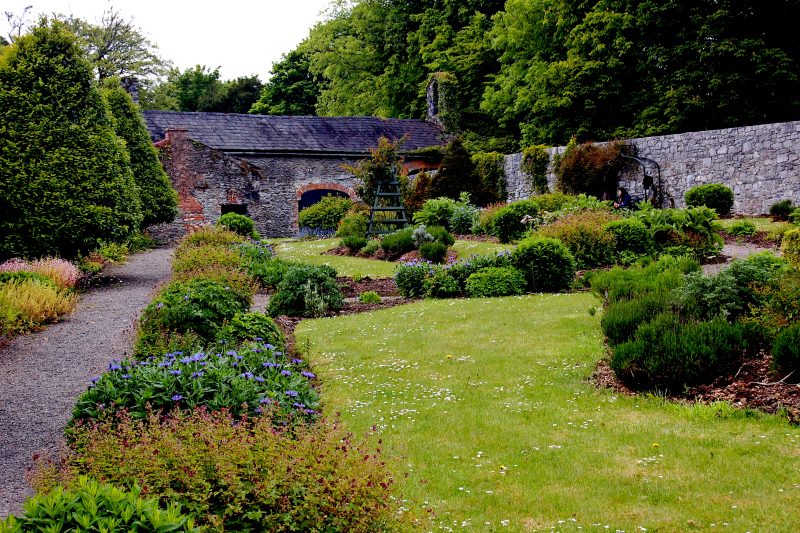 A lush apothecary garden during the Regency period.