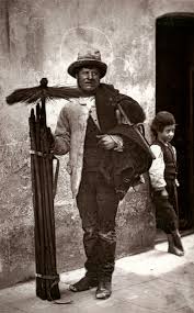 A black and white photo of a chimney sweep during the Regency era.