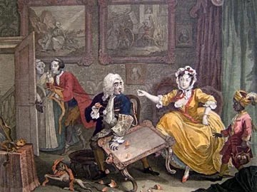 A woman sitting and talking with a man at a table.