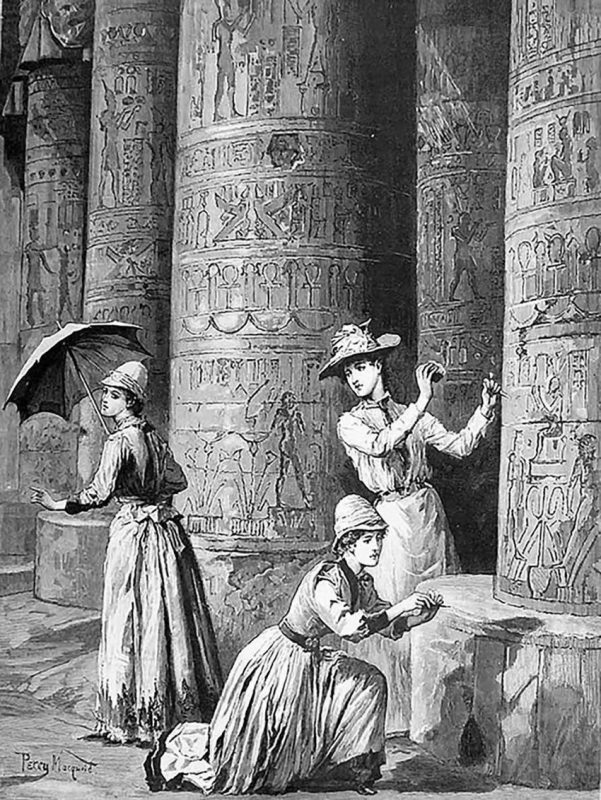 Three women examining Egyptian hieroglyphic symbols etched on towering beams.